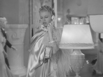 Movie still from “Top Hat” (1935), directed by Mark Sandrich – A black and white photo of a woman talking on a phone; Medium shot, High angle