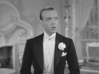 Movie still from “Top Hat” (1935), directed by Mark Sandrich – A black and white photo of a man in a tuxedo; Close Up shot, Low angle