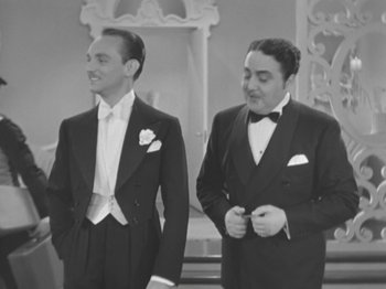 Movie still from “Top Hat” (1935), directed by Mark Sandrich – Two men in tuxedos standing next to each other; Medium shot, Low angle