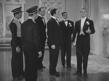 Movie still from “Top Hat” (1935), directed by Mark Sandrich – A black and white photo of a group of men in tuxedos; Wide shot, High angle