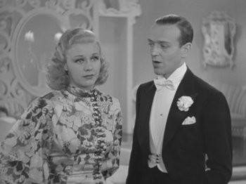 Movie still from “Top Hat” (1935), directed by Mark Sandrich – A man and a woman standing next to each other in formal wear; Medium shot, Low angle