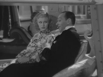 Movie still from “Top Hat” (1935), directed by Mark Sandrich – A man and a woman sitting on a couch in front of each other; Medium shot, High angle