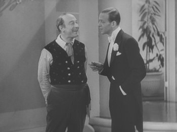 Movie still from “Top Hat” (1935), directed by Mark Sandrich – A man and a man standing next to each other; Medium shot, Over the shoulder angle