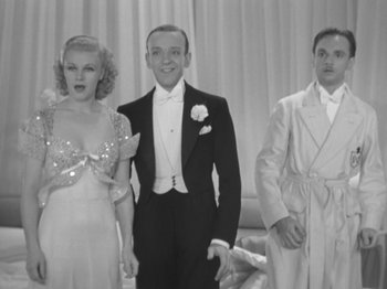 Movie still from “Top Hat” (1935), directed by Mark Sandrich – A black and white photo of a man and two women in formal wear; Medium shot, Low angle