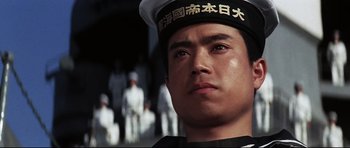 Movie still from “Tora! Tora! Tora!” (1970), directed by Kinji Fukasaku – A person wearing a hat; Close Up shot, Low angle