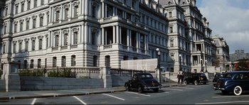 Movie still from “Tora! Tora! Tora!” (1970), directed by Kinji Fukasaku – An old car parked on the side of the street; Extreme Wide shot, Low angle