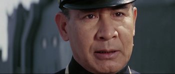 Movie still from “Tora! Tora! Tora!” (1970), directed by Kinji Fukasaku – An older man wearing a uniform and a hat; Close Up shot, Low angle