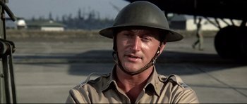 Movie still from “Tora! Tora! Tora!” (1970), directed by Kinji Fukasaku – A man wearing a military uniform and a helmet; Close Up shot, Over the shoulder angle