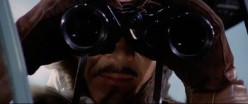 Movie still from “Tora! Tora! Tora!” (1970), directed by Kinji Fukasaku – A person looking through binoculars; Extreme Close Up shot, Low angle