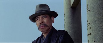 Movie still from “Tora! Tora! Tora!” (1970), directed by Kinji Fukasaku – A man with a mustache and a hat on; Close Up shot, Low angle