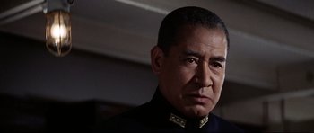 Movie still from “Tora! Tora! Tora!” (1970), directed by Kinji Fukasaku – A person wearing a uniform; Close Up shot, Low angle