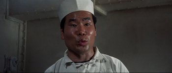 Movie still from “Tora! Tora! Tora!” (1970), directed by Kinji Fukasaku – A man wearing a white hat and a white shirt; Close Up shot, Low angle