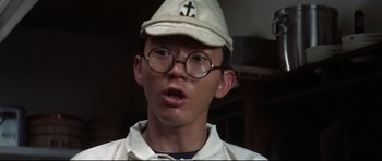 Movie still from “Tora! Tora! Tora!” (1970), directed by Kinji Fukasaku – A young man wearing glasses and a hat; Close Up shot, High angle