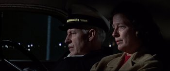 Movie still from “Tora! Tora! Tora!” (1970), directed by Kinji Fukasaku – A man and a woman sitting in the back of a car; Close Up shot, Low angle