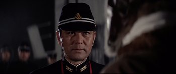 Movie still from “Tora! Tora! Tora!” (1970), directed by Kinji Fukasaku – A person wearing a uniform; Close Up shot, Low angle