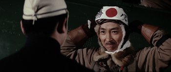 Movie still from “Tora! Tora! Tora!” (1970), directed by Kinji Fukasaku – An older man wearing an old japanese pilot's hat; Close Up shot, Low angle