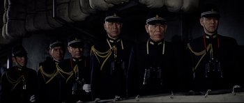 Movie still from “Tora! Tora! Tora!” (1970), directed by Kinji Fukasaku – A group of men standing next to each other in uniform; Medium shot, Low angle