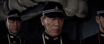 Movie still from “Tora! Tora! Tora!” (1970), directed by Kinji Fukasaku – A man wearing a uniform and wearing a hat; Close Up shot, Low angle