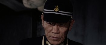 Movie still from “Tora! Tora! Tora!” (1970), directed by Kinji Fukasaku – A person wearing a uniform; Close Up shot, Low angle
