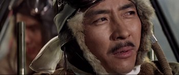 Movie still from “Tora! Tora! Tora!” (1970), directed by Kinji Fukasaku – A person wearing a helmet; Close Up shot, Low angle