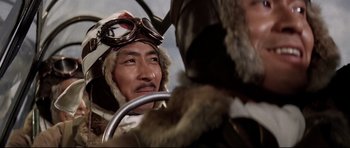 Movie still from “Tora! Tora! Tora!” (1970), directed by Kinji Fukasaku – A man in a pilot's uniform sitting in an airplane cockpit; Close Up shot, Low angle