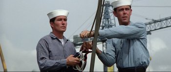 Movie still from “Tora! Tora! Tora!” (1970), directed by Kinji Fukasaku – Two men in sailor's hats are holding a rope; Medium shot, Low angle