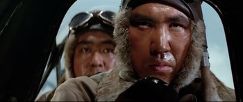 Movie still from “Tora! Tora! Tora!” (1970), directed by Kinji Fukasaku – Two asian men wearing winter coats and fur hats; Close Up shot, Low angle