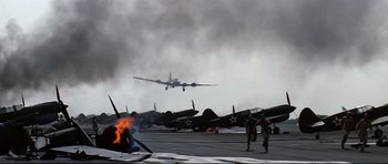Movie still from “Tora! Tora! Tora!” (1970), directed by Kinji Fukasaku – An airplane is flying in the air on a cloudy day; Wide shot, Low angle