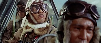 Movie still from “Tora! Tora! Tora!” (1970), directed by Kinji Fukasaku – A man in a helmet and goggles sitting in a car; Close Up shot, Low angle