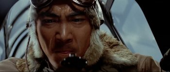 Movie still from “Tora! Tora! Tora!” (1970), directed by Kinji Fukasaku – A man in a fur coat and goggles holding a cell phone; Close Up shot, Low angle