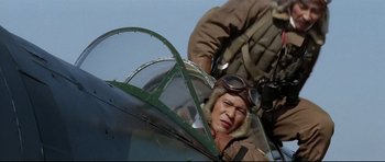 Movie still from “Tora! Tora! Tora!” (1970), directed by Kinji Fukasaku – An older man in an old style fighter jet; Medium shot, Low angle