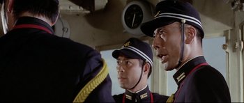 Movie still from “Tora! Tora! Tora!” (1970), directed by Kinji Fukasaku – A group of men standing next to each other on top of a boat; Close Up shot, Low angle