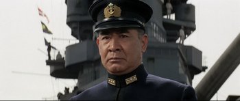 Movie still from “Tora! Tora! Tora!” (1970), directed by Kinji Fukasaku – A person wearing a uniform; Close Up shot, Low angle