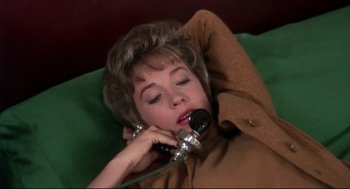 Movie still from “Torn Curtain” (1966), directed by Alfred Hitchcock – A woman laying down talking on a phone; Close Up shot, High angle