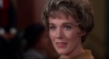 Movie still from “Torn Curtain” (1966), directed by Alfred Hitchcock – A woman's face in a brown dress; Close Up shot, Over the shoulder angle