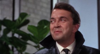 Movie still from “Torn Curtain” (1966), directed by Alfred Hitchcock – A person wearing a suit and tie; Close Up shot, Over the shoulder angle