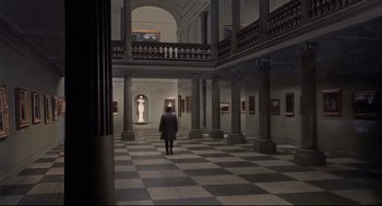 Movie still from “Torn Curtain” (1966), directed by Alfred Hitchcock – A person is walking through a hall of a museum; Extreme Wide shot, High angle