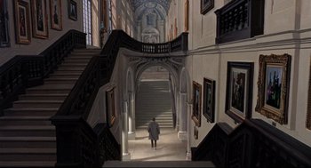 Movie still from “Torn Curtain” (1966), directed by Alfred Hitchcock – A man walking down a staircase in a building; Extreme Wide shot, High angle