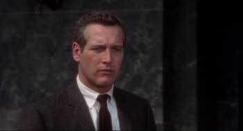 Movie still from “Torn Curtain” (1966), directed by Alfred Hitchcock – A person wearing a suit and tie; Close Up shot, Over the shoulder angle