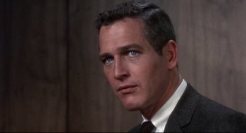 Movie still from “Torn Curtain” (1966), directed by Alfred Hitchcock – A person wearing a suit and tie; Close Up shot, Over the shoulder angle