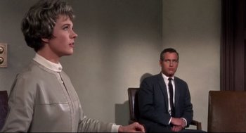 Movie still from “Torn Curtain” (1966), directed by Alfred Hitchcock – A man and a woman sitting at a table; Medium shot, Over the shoulder angle