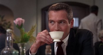 Movie still from “Torn Curtain” (1966), directed by Alfred Hitchcock – A person drinking a cup of coffee; Close Up shot, Low angle