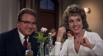 Movie still from “Torn Curtain” (1966), directed by Alfred Hitchcock – A man and a woman sitting at a dinner table; Close Up shot, Low angle