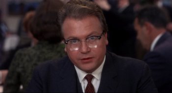 Movie still from “Torn Curtain” (1966), directed by Alfred Hitchcock – A person wearing glasses and a suit; Close Up shot, Over the shoulder angle