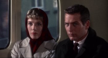 Movie still from “Torn Curtain” (1966), directed by Alfred Hitchcock – A man and a woman sitting next to each other on a train; Close Up shot, Low angle