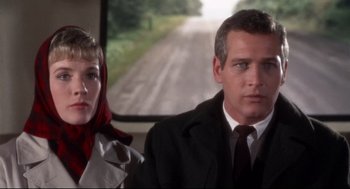 Movie still from “Torn Curtain” (1966), directed by Alfred Hitchcock – A man and a woman standing next to each other on a train; Close Up shot, Low angle