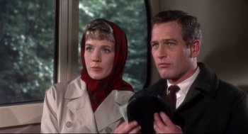 Movie still from “Torn Curtain” (1966), directed by Alfred Hitchcock – A man and a woman standing next to each other on a train; Close Up shot, Low angle