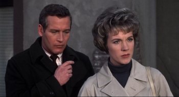 Movie still from “Torn Curtain” (1966), directed by Alfred Hitchcock – A man and a woman standing next to each other; Close Up shot, Low angle