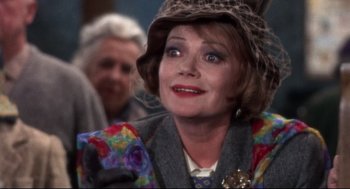 Movie still from “Torn Curtain” (1966), directed by Alfred Hitchcock – An older woman wearing a leopard print hat; Close Up shot, Over the shoulder angle