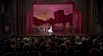 Movie still from “Torn Curtain” (1966), directed by Alfred Hitchcock – A crowd of people sitting in front of a stage; Extreme Wide shot, High angle